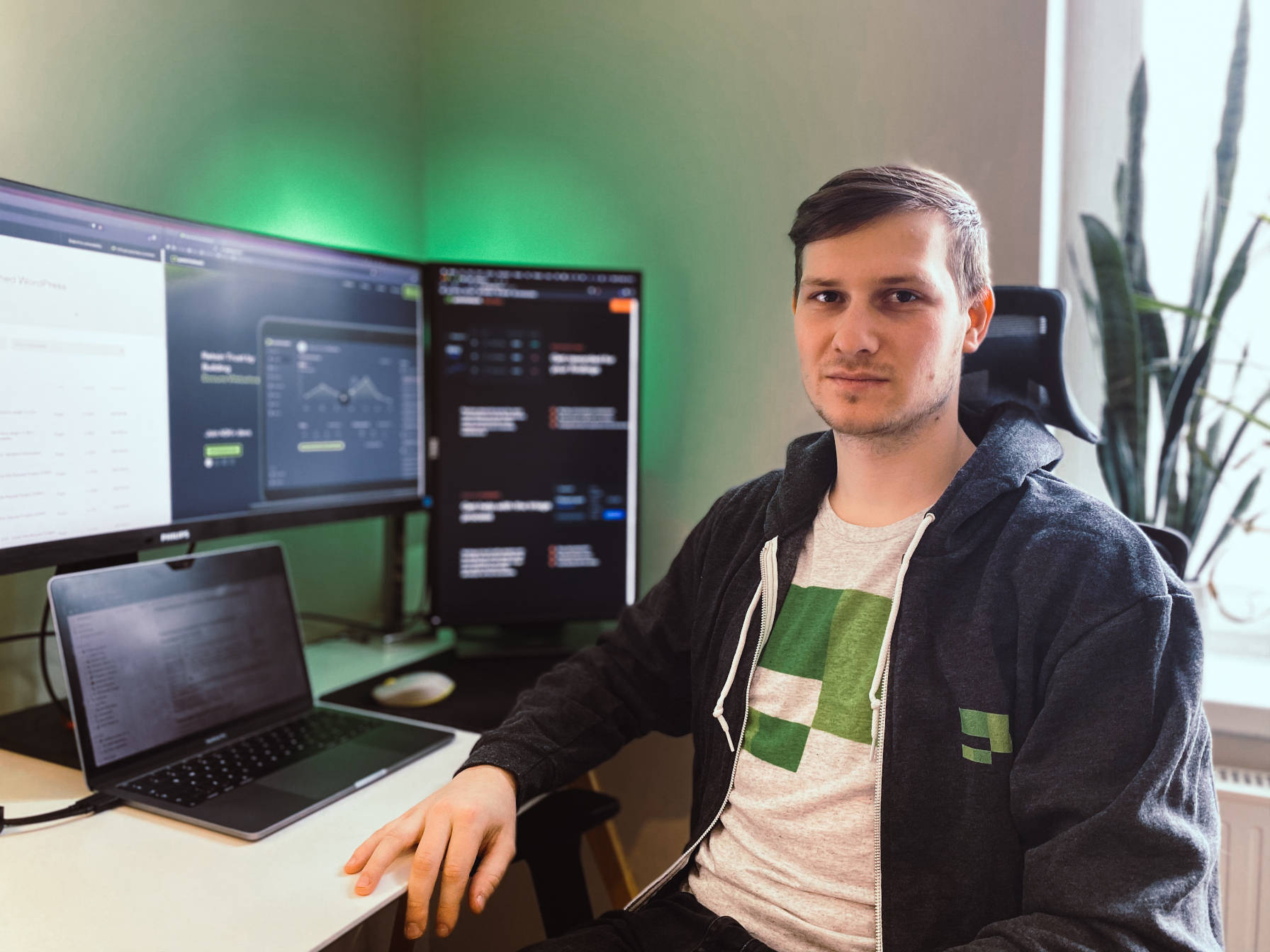 Patchstack founder and CEO, Oliver Sild, sitting at a desk with laptop and monitors.