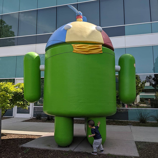Yellow Masked Android Statue At Google